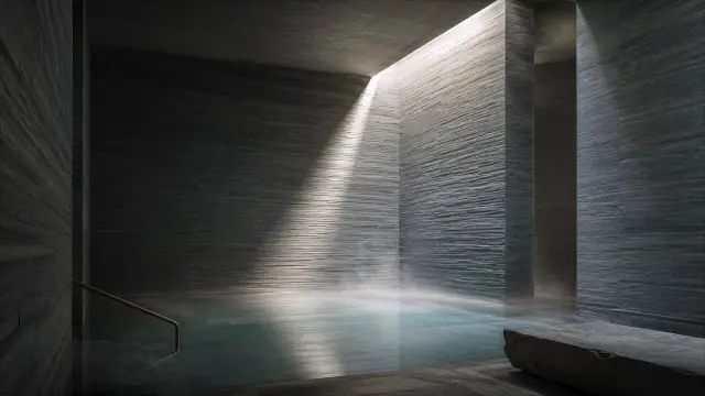 piscina de piedra con luz cálida y niebla